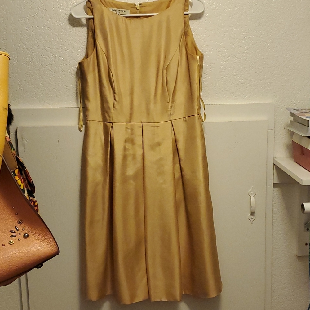 Yellow sleeveless dress.